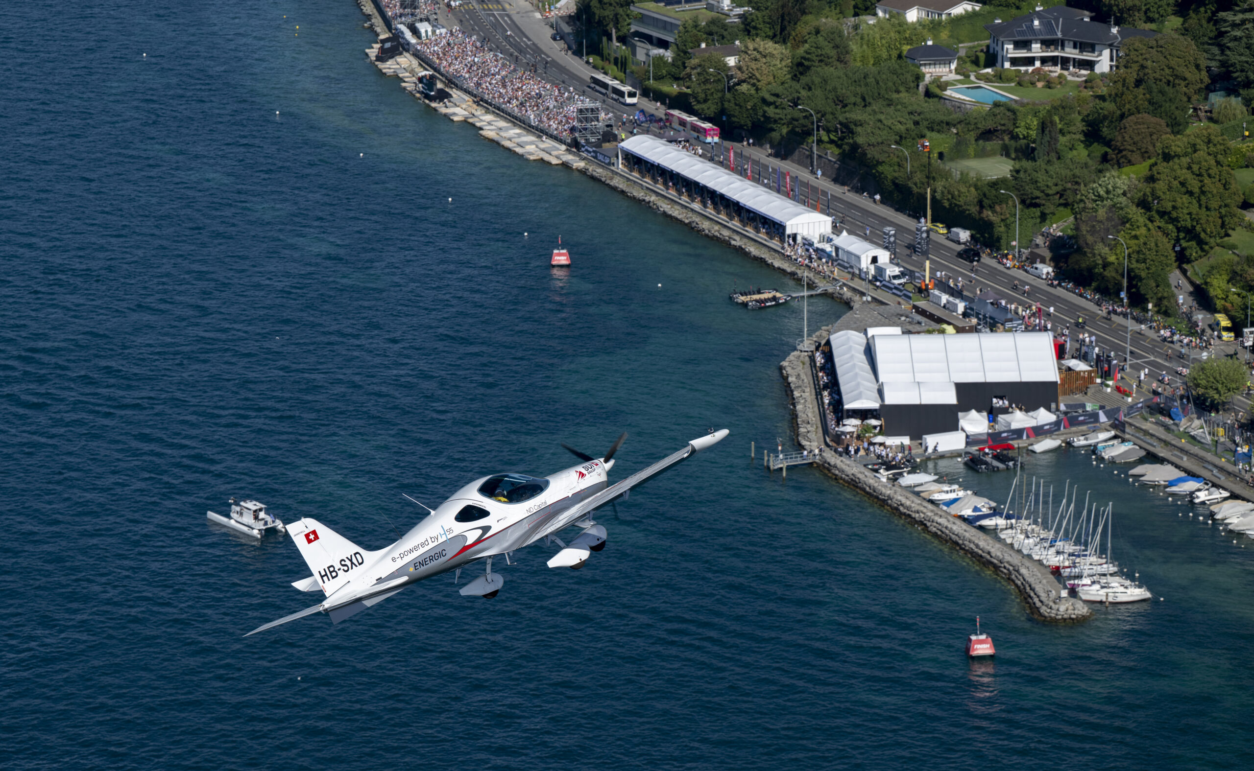 Switzerland SailGP Team branded electric plane fly over the Adrenaline Lounge and the Premium Waterfront Lounge, on Race Day 1 of the Rolex Switzerland Sail Grand Prix held in Geneva, Switzerland Saturday 20 September 2025. Rolex SailGP Championship Event 10 2025 Season. Photo: Ricardo Pinto for SailGP. Handout image supplied by SailGP