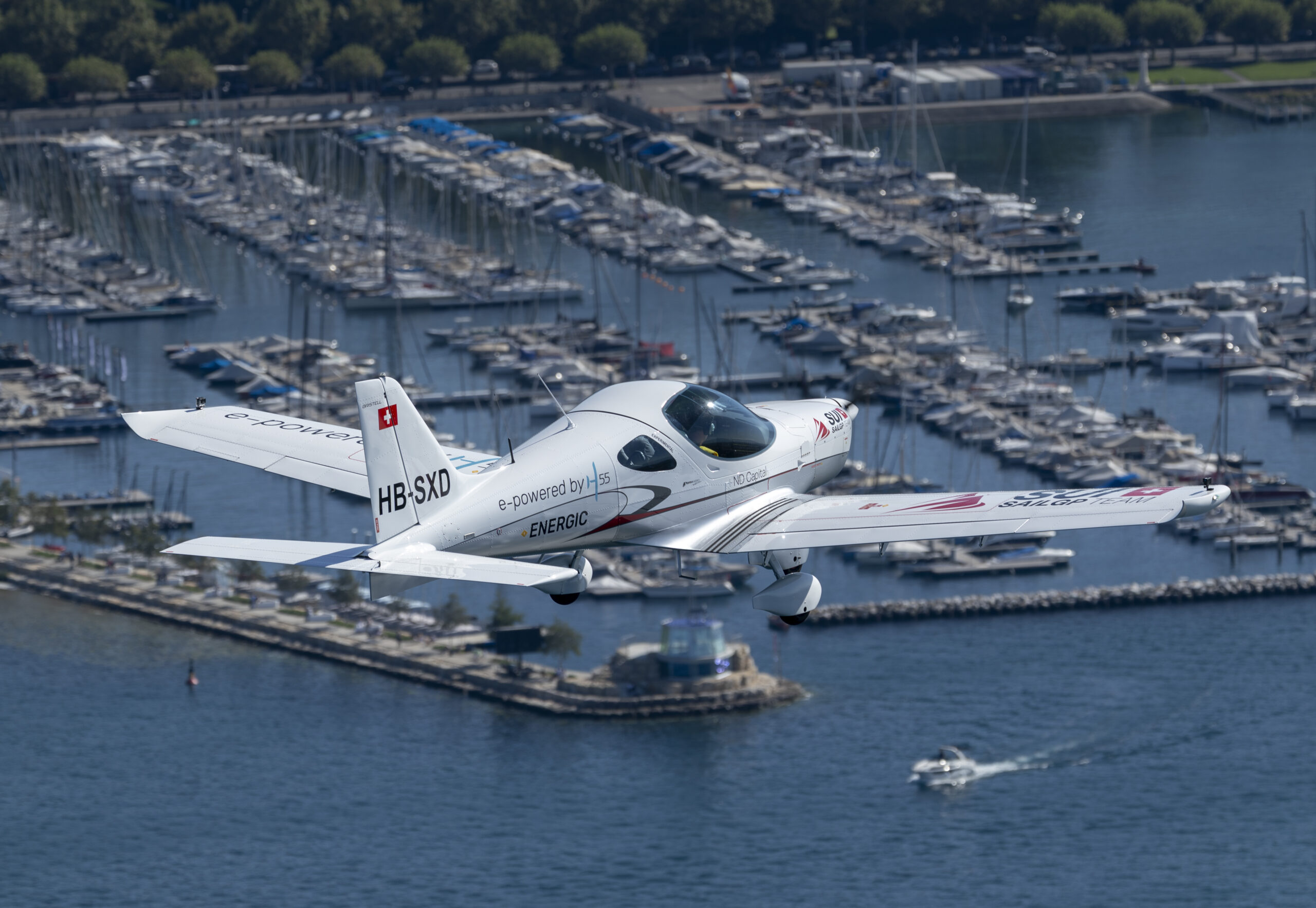 Switzerland SailGP Team branded aeroplane flying over the marina during a practice session ahead of the Rolex Switzerland Sail Grand Prix held in Geneva, Switzerland Friday 19 September 2025. Rolex SailGP Championship Event 10 2025 Season. Photo: Samo Vidic for SailGP. Handout image supplied by SailGP